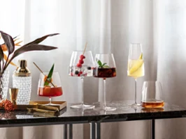 Des verres MetroChic élégants avec différents cocktails sur une table en marbre Différents cocktails servis dans d’élégants verres MetroChic sur une table en marbre à côté d’une plante.