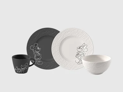 Collection Image - Manufacture Mickey Mouse An arrangement of two plates of same sizes and a cup and a bowl, Mickey Mouse and Mini Mouse, presented on a light background.