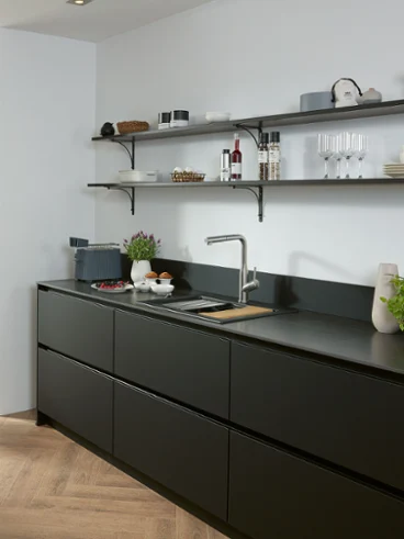 Une robinetterie de cuisine Subway Style Shower dans une cuisine noire Une robinetterie de cuisine Subway Style Shower en acier inoxydable massif dans une cuisine noire avec des étagères et un évier.