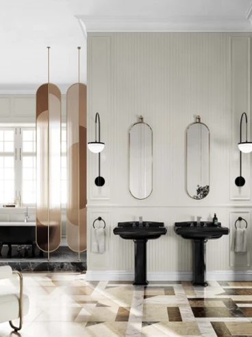 Une salle de bains moderne avec deux lavabos noirs et une baignoire en îlot Une salle de bains moderne avec deux lavabos noirs, de grands miroirs, un fauteuil blanc et une baignoire en îlot près de la fenêtre. Le sol est en marbre et il y a de hautes cloisons de séparation couleur bronze.