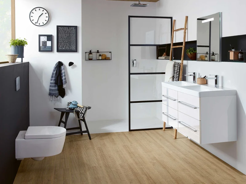 Une salle de bains moderne avec des WC suspendus Avento, un plan double blanc, une douche vitrée et des éléments en bois